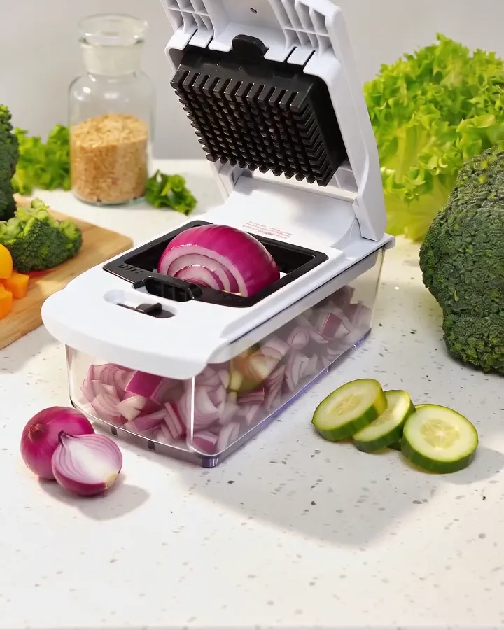 Fullstar vegetable chopper with a diced red onion in the container on a bright kitchen counter